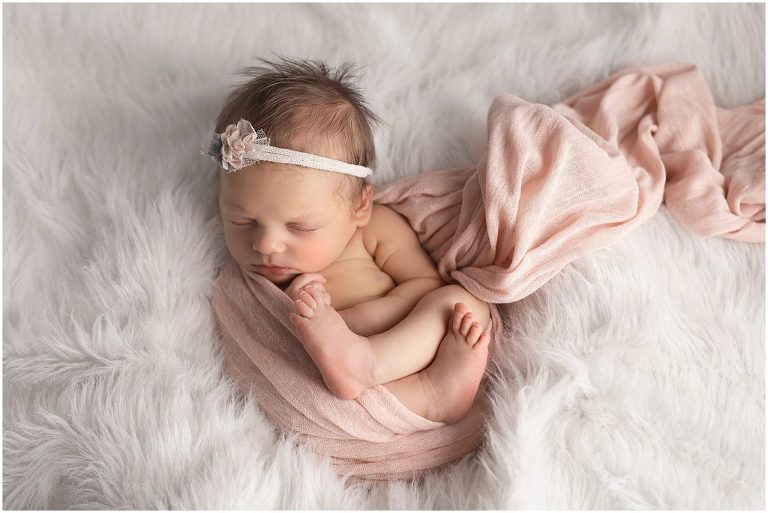 Newborn pictures, white and pink with a cream tieback. 