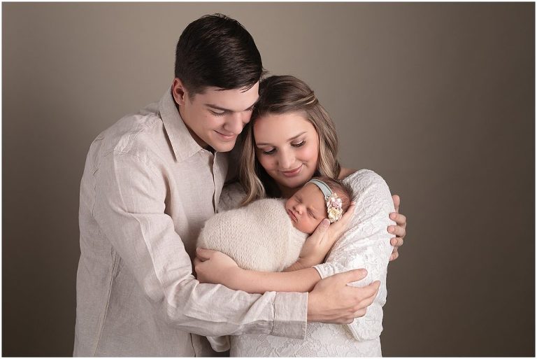 Neutral family picture in studio with newborn. 